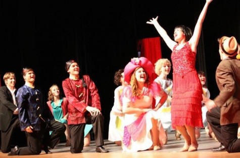 At the final moments of the final bows of the production, the cast beams. Olivia Pastore, pictured in the pink dress beside Millie, is bowing for the last time in a musical for Lambert High School.