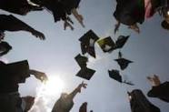 Seniors throwing graduations caps in the air.