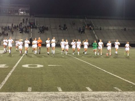 The Girls' Varsity team takes a victory jog after their incredible win over Grayson.