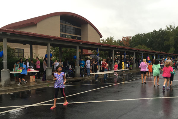 Despite the rain, carnival attenders have fun by socializing and exchanging tickets for prizes.