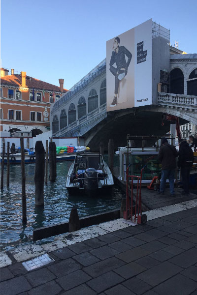 Realto Bridge in Venice, Italy remains under construction as the morning sun rises.
