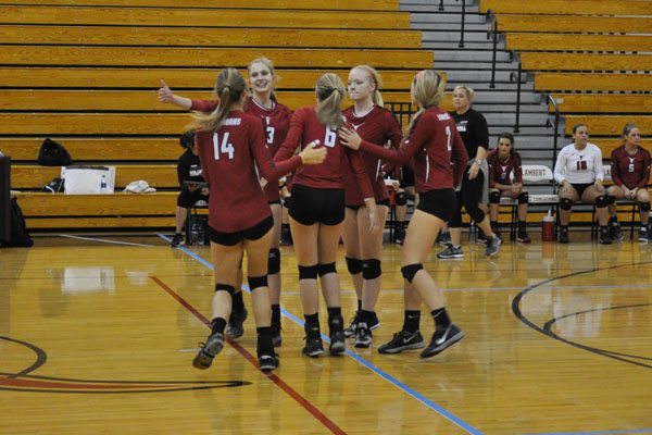 Lambert Volleyball celebrates after a win against Dunwoody