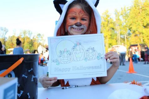 Students from Mashburn Elementary School gather around in the parking lot for a Trunk or Treat event. Willow, a second grader, was the first one to enter into the coloring contest. As she started coloring meticulously, she said, "It's hard to color in the lines!" This coloring contest was one of the most popular stations at this event; students lined up after one another eagerly, hoping to win their class free breakfast.