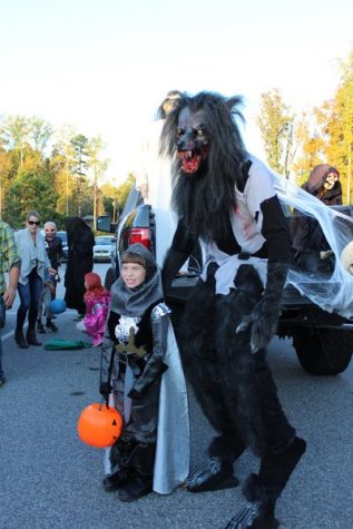 Although the rules said "no scary trunks", the owners of this truck decided to go against it. Ghost statues were put up all around the car and the owner even bought himself a terrifying wolf costume, with the hopes of scaring children away. However, that didn't stop this brave knight from building up the courage to take a picture next to this creepy creature.