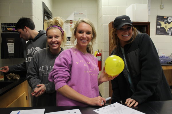 Students in Mrs. McAllisters Forensics class pridefully hold up their balloon after the DNA Fingerprinting lab. 