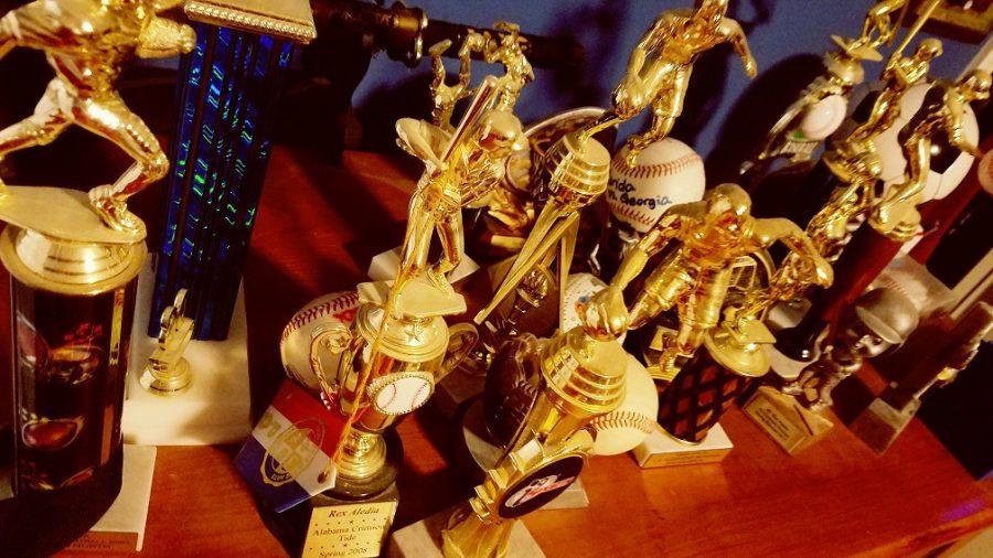 Participation trophies collect dust and are left forgotten on a dresser.