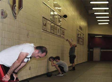 The cross-fit club members, including the coaches, work hard to keep up with their own pace in successfully performing through each exercises.