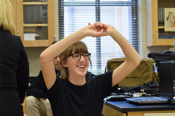 Forensic student Hannah Saylor raises her hands as a part of a polygraph demonstration.
