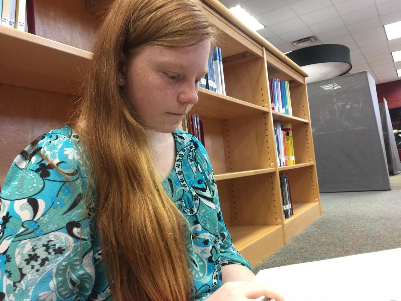 Olivia Sullivan is one of the many students who utilize Lamberts library. Which do you prefer: paper books or e-books?