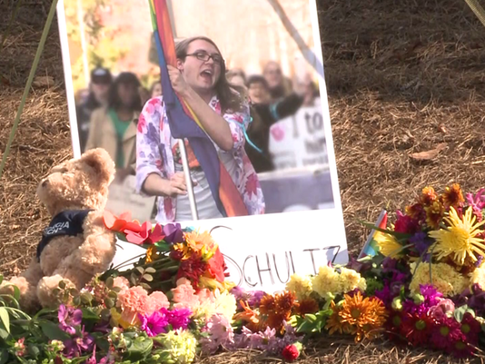 Flowers and stuffed animals can be seen placed around memorials for Schultz.