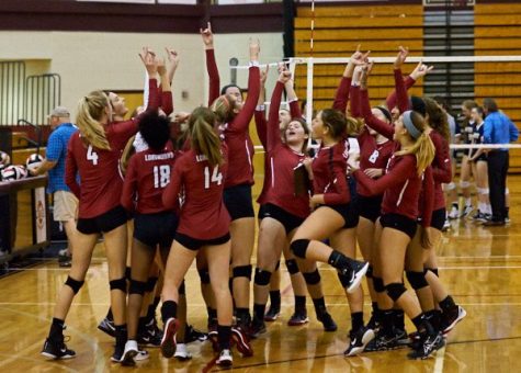 The volleyball team celebrates after a win that sends them into the elite eight round.