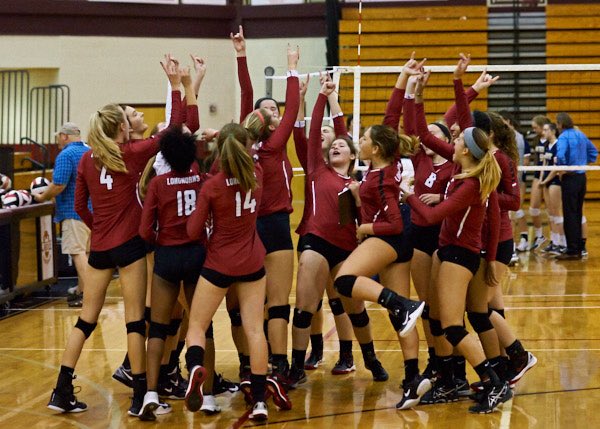 The volleyball team celebrates after a win that sends them into the elite eight round.