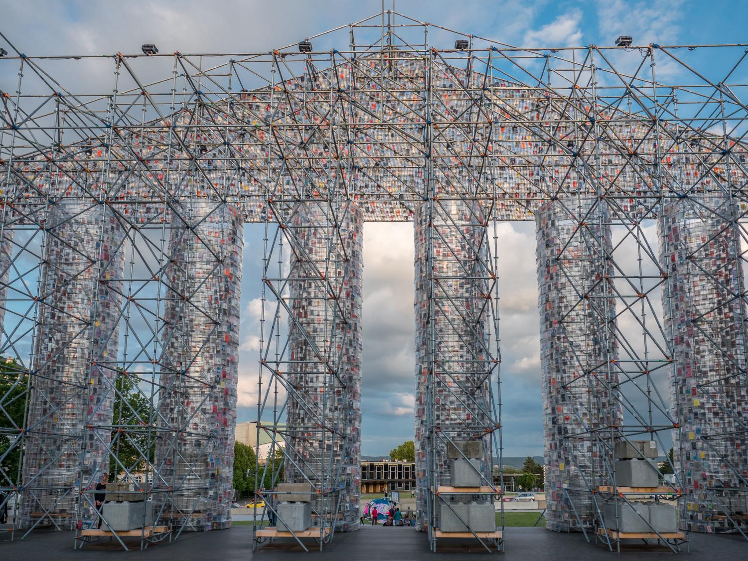 The Parthenon of Books, a replica of the Greek Parthenon made with over 100,000 banned books, that was displayed behind the Fridericianum museum, a former library that was the site of a 1933 ███ book burning.
This installation was part of a German art festival organized to stand for the free circulation of ideas and knowledge.
Photo by Heinz Bunse, published July 15, 2017, Some rights reserved, license link: https://creativecommons.org/licenses/by/2.0/,
Original link of work: https://www.flickr.com/photos/buffo400/35972599702/in/photolist-WNLYCf-5vRDJF-4z5AY2-9EKZEo-7UWHnT-8GLYig-adXdS4-5i34i4-fnVJ7t-5eTZai-6yhLEr-4z9LEf-ktgakx-kAfeef-ciLT1h-8DTTGG-58tXBb-4Rw5kL-24y96R-57s4HN-cjf8xs-dVy7PS-ZCuX5H-51mjSz-e47moD-4z9NVY-idkfLv-4z5xaM-4z9LTQ-eTjc1W-caR8tq-5Xbgm2-6RbFko-5wx88t-87b8gN-7QR7pg-8A7L1v-ecAEyh-6BzSc1-bmHxE1-UkkaAW-4CCpY6-71ZSKY-kAdkcH-6fSSyE-TYP63D-7k6Kmu-7U9YpL-61pcSS-7SBYUk