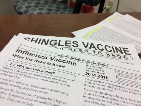 Photo by Bill Smith, published November 7, 2014, Some rights reserved, License link: http://bit.ly/1mhaR6e, original link to work: http://bit.ly/2n5HyYp, Papers are seen with information regarding influenza.