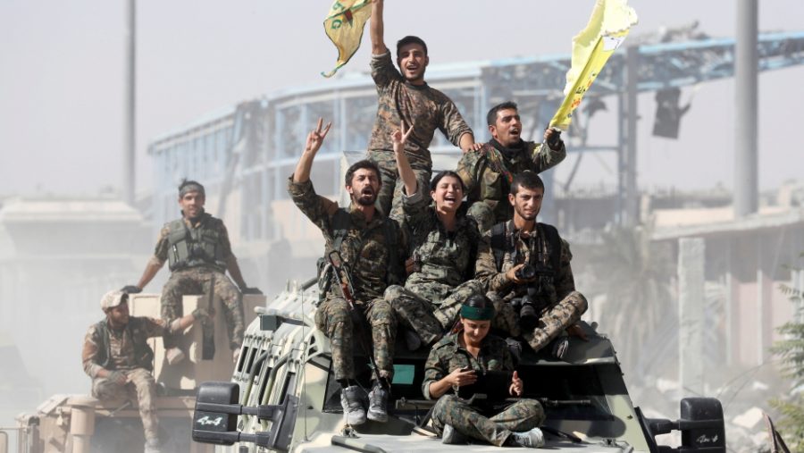 Syrian forces celebrate the liberation of Raqqa from ISIS control. Credit: Erik De Castro/Reuters, published on October 17, 2017, link to original https://media.pri.org/s3fs-public/styles/story_main/public/story/images/RTS1GUES.jpg?itok=w-7gAkg1