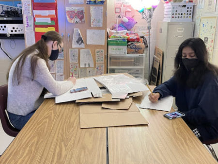 In room 1886 of Lambert High School, two Student Government Association Sophomores are working on the decorations for the upcoming trunk or treat. Their goal in the picture was to sketch out designs and lettering for the display. (Lambert Post/ Ashley Choi)
