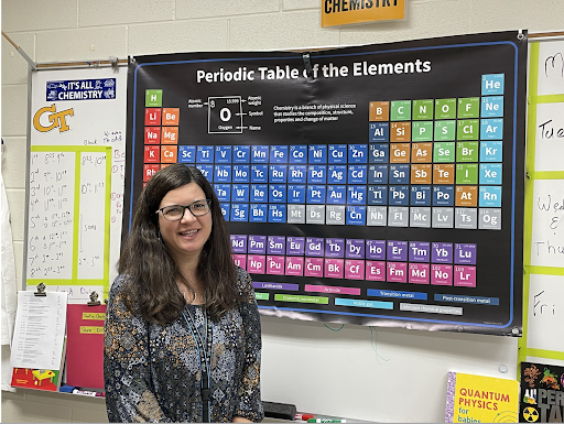 A photo of Mrs. Sharer in front of the Periodic Table of the Elements in her classroom, Wednesday, October 20, 2021. (The Lambert Post/ Hunter Dzerve)
