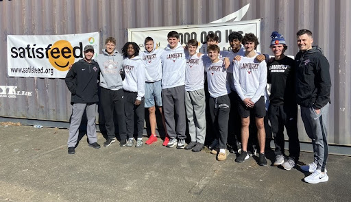 The Lambert Boy’s Basketball Team poses for a picture after they helped serve the community, October 23.  The teams have ranked very high in state and nationals in the past years. (Taken from @lamberthoops Twitter)
