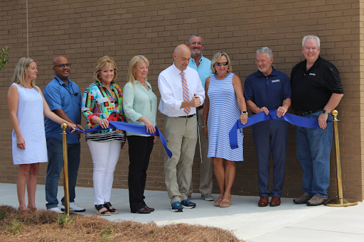 The principal of Gateway Academy, Drew Hayes, cut the ribbon to officially open the academy. Taken Saturday, July 24, 2021. (Forsyth County News) 
