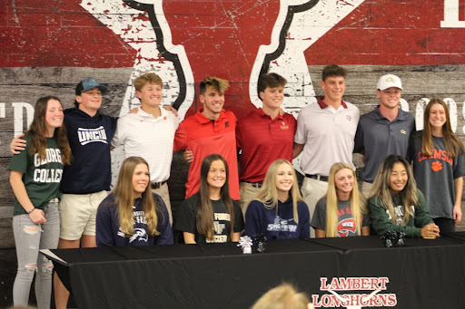 Upper row left to right: Maddie Todd, Paddy Morris, Nathan Dvorsky, Ashton Smith, Justin Haskins, Colin Linder, Parker Brosius, Kate Borner. Bottom row left to right: Sara Maschmier, Carly Wilson, Taylor Nelson, Averi Cline, Iris Cao. All of the November signees lined up at the end of the event celebrating their accomplishments (The Lambert Post/Photo by Colby Langley)
