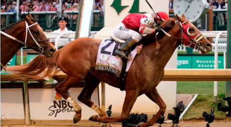 Jockey Sonny Leon and horse Rich Strike gallop across the finish line, winning the 148th running of the Kentucky Derby. Taken on May 17, 2022 from CNN.com. 
