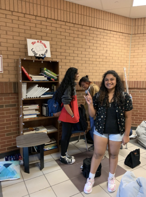 This is a picture of, creator, Ananya Suresh standing next to the “Take a Book, Leave a Book,” bookshelf. The bookshelf was established this school year and is located upstairs near the gym. Taken by Juhi Bhatia on September 8, 2022.