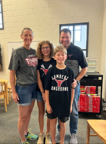 Photo of Coach Pate in the library with his wife, Jessica, and his two kids, Ansley and Oliver after he won Teacher of the Year. Taken on Friday, September 2 2022. 