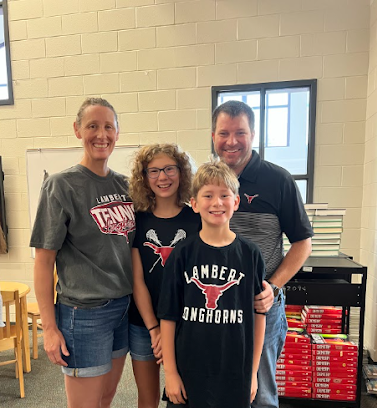 Photo of Coach Pate in the library with his wife, Jessica, and his two kids, Ansley and Oliver after he won Teacher of the Year. Taken on Friday, September 2 2022. 