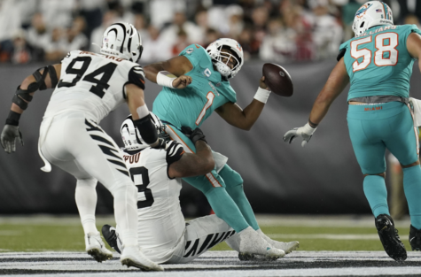 Miami Dolphins quarterback Tua Tagovailoa gets sacked by Cincinnati Bengals Defensive tackle Josh Tupuo. The result of the play would be a concussion suffered by Tagovailoa. (JOSHUA A. BICKEL/ASSOCIATED PRESS).