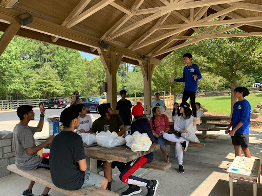 Aryan Batada, the President of 350 Lambert, a climate change activism club, is seen leading a cleanup at Sims Lake Park. Taken by Richa Sharma, September 17th, 2022.