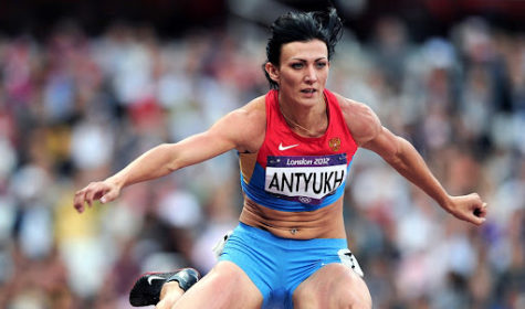 Natalya Antyukh jumping over a hurdle in the 2012 London Olympic 400 meter hurdle race. Taken by Mark Shearman.