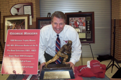 Dr. Davison posed with the Heisman Trophy in 2009 during Lambert’s first school year. Courtesy of Dr. Gary Davison.