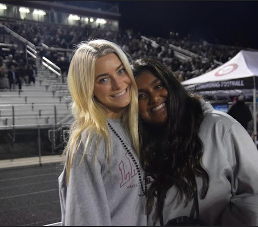 Diya Patel and Ella Majoli on the sideline during a home game against South Forsyth. Taken by Allison Mitchamore.
