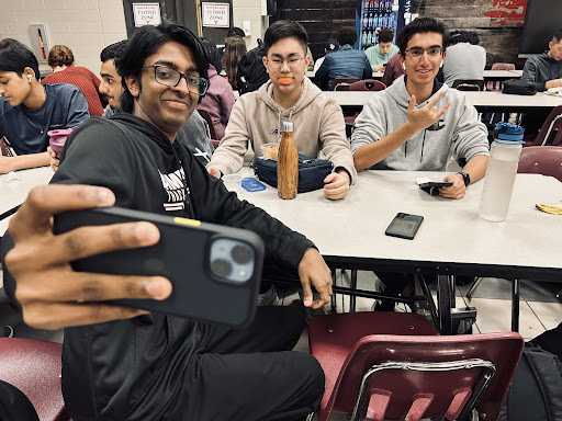 Three Lambert students taking their BeReal during lunch, specifically posing for the picture. Photograph taken by Chitvan Singh.