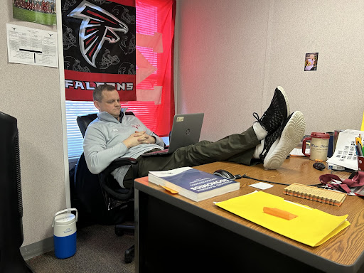 Lambert AP Macroeconomics teacher and soccer coach Mr. Shroyer watching a movie during some downtime. Photograph by Chitvan Singh, taken on February 13, 2023.