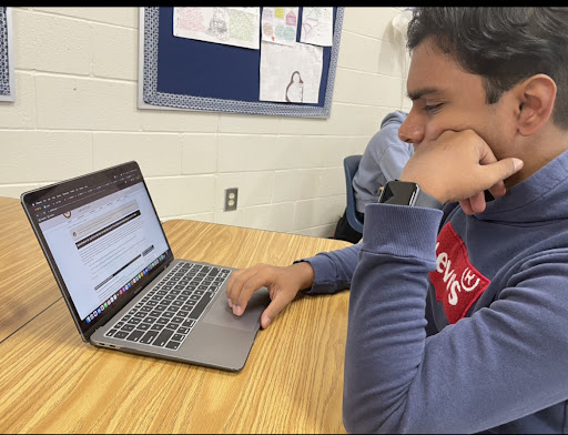 Lambert junior Ashan Galhena reading about the takeaways of Section 230. Taken by Ashley Choi.