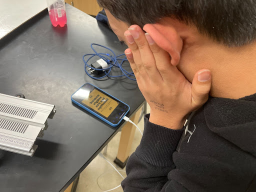 A Lambert student looking upon a poster for Amnesty International, concerned upon learning about the drug epidemic in the United States. Taken by Chitvan Singh on February 27, 2023.