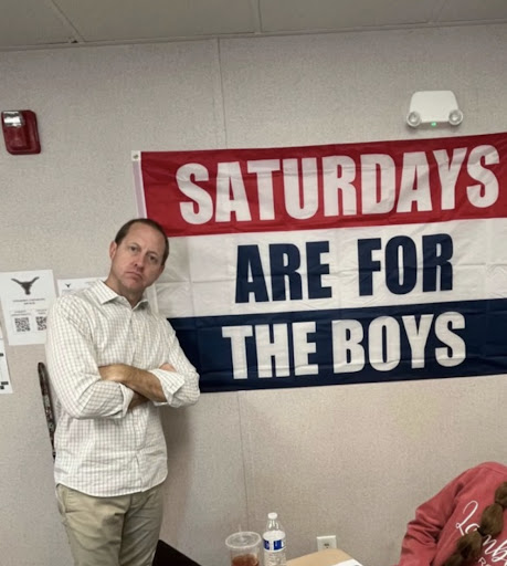 Mr.Jakaitis posed in front of his Saturdays Are For the Boys flag gifted to him by students. Taken by Jane Fang on March 7th, 2023.
