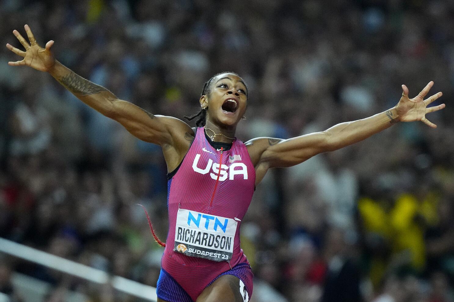 ShaCarri Richardson, of the United States, celebrates after winning the gold medal in the final of the Womens 100-meters during the World Athletics Championships in Budapest, Hungary, Monday, Aug. 21, 2023.  (AP Photo/Petr David Josek)