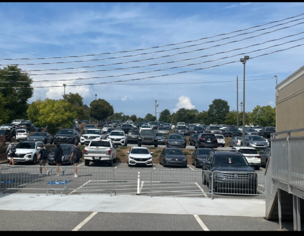 Caption: Lambert’s Gym parking lot predominantly occupied by students. (Ashley Choi/Lambert Post) 
