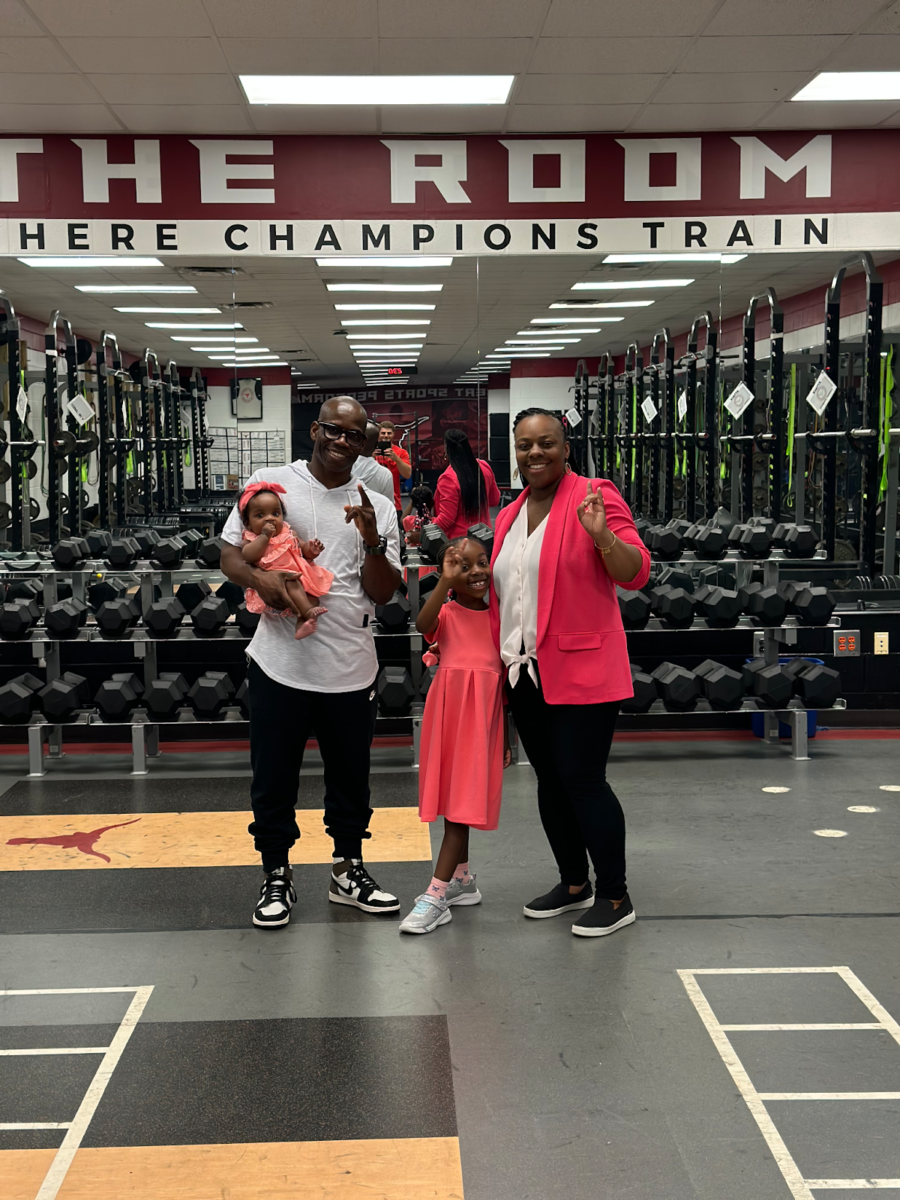 A picture of Coach Mattair with his family in the weight room. Taken by Nate Richardson on September 1st, 2023.

