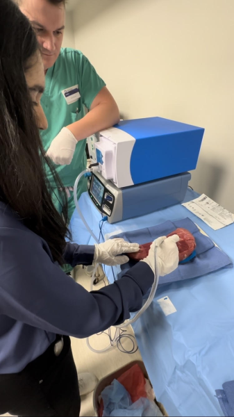 Dia Patil at the 21st Century Healthcare and Leadership Camp using an electro cauterizer and performing micro robotic surgery (Image provided by Dia Patil).