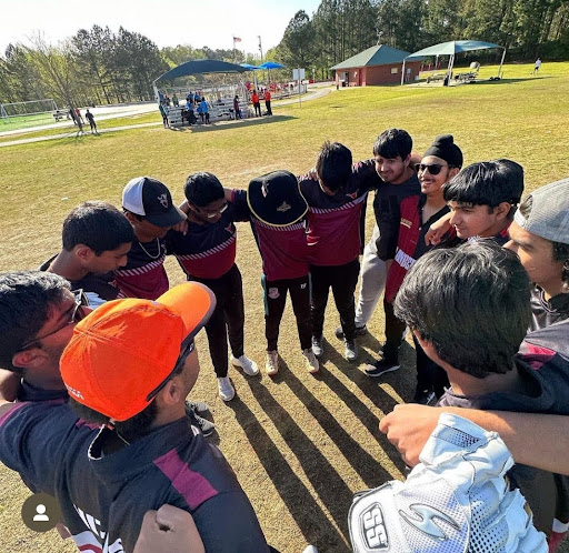 Image of Lambert Cricket Team in a huddle at Shakerag park. Courtesy of Aritra Bhattacharya, March 2023.
