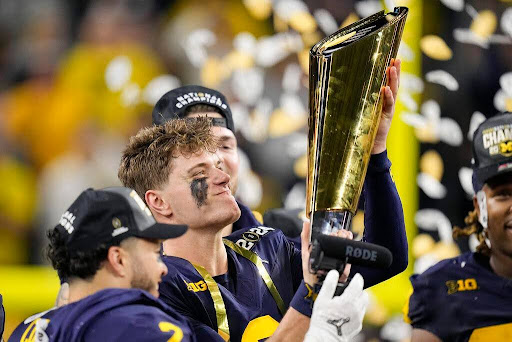 J.J. McCarthy, the quarterback for the University of Michigan, holding the trophy after winning the College Football Championship. This was taken on Jan. 8, 2024 in Houston, Texas. (AP Photo/Eric Gay).