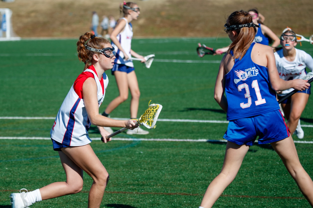 Picture of Megan Snyder playing at a game against Carolina Comets (Courtesy of the Lambert Girls Lacrosse Instagram).