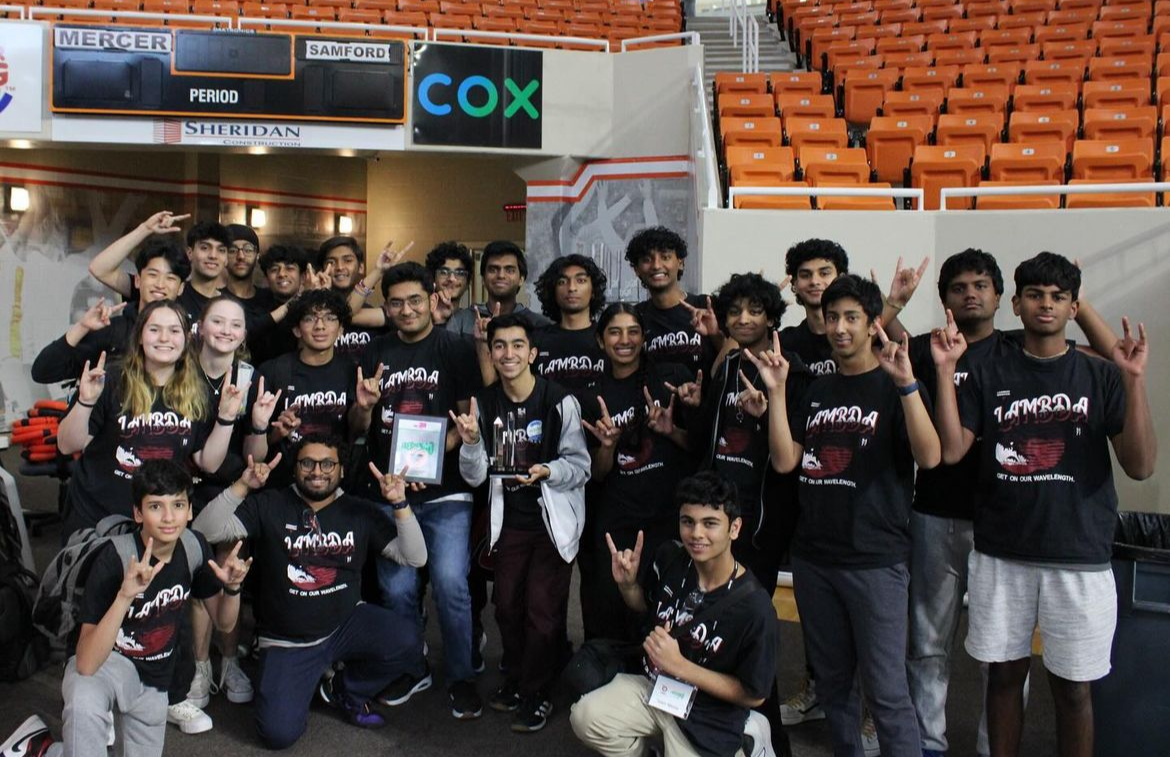 This shows the Robotics Club posing for a photo after receiving news that they have qualified to go to the 2024 VEX Robotics Worlds Championship. Lambert Robotics/Instagram

