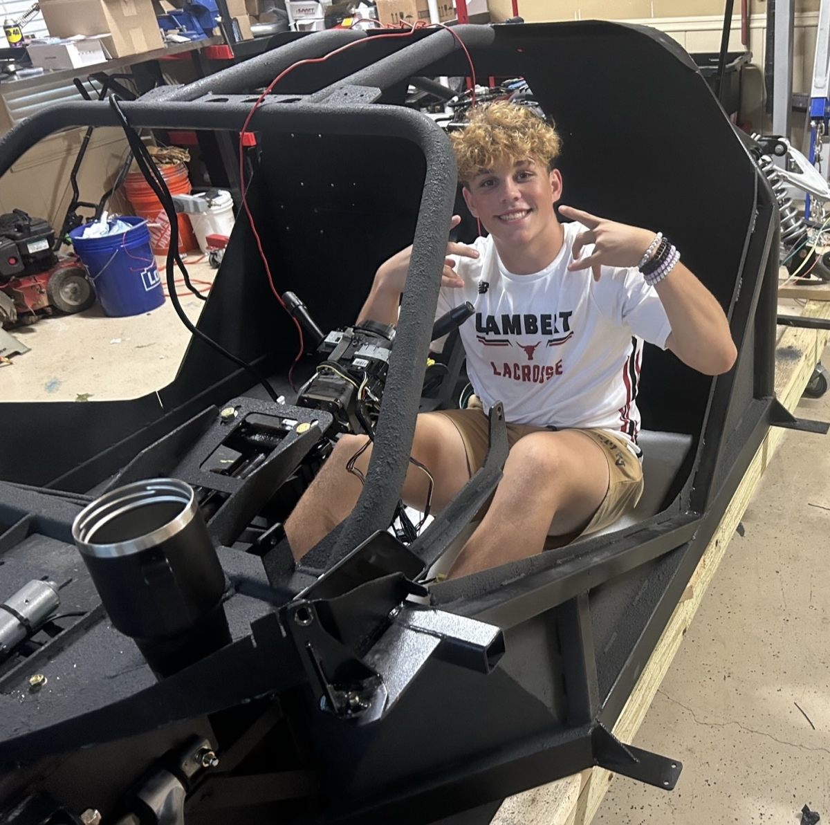 Adam in his own built car that he is currently working on in his garage, where he does most of the mechanic work.  Photo Credit (Adam Rotunda)