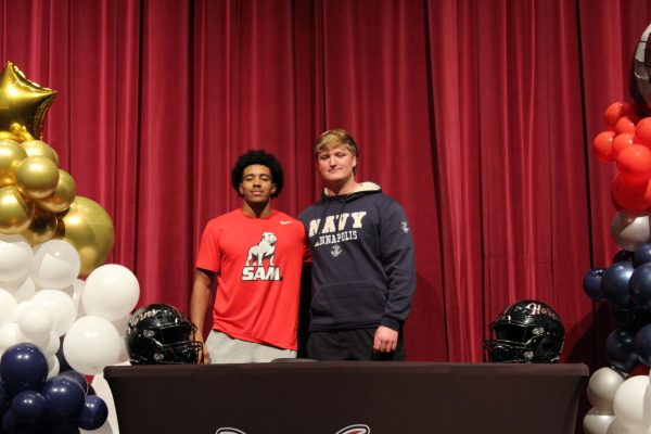 Football players Cam Bland and Jackson DeLoach posing during their signing day event. (Josh Mui/The Lambert Post)