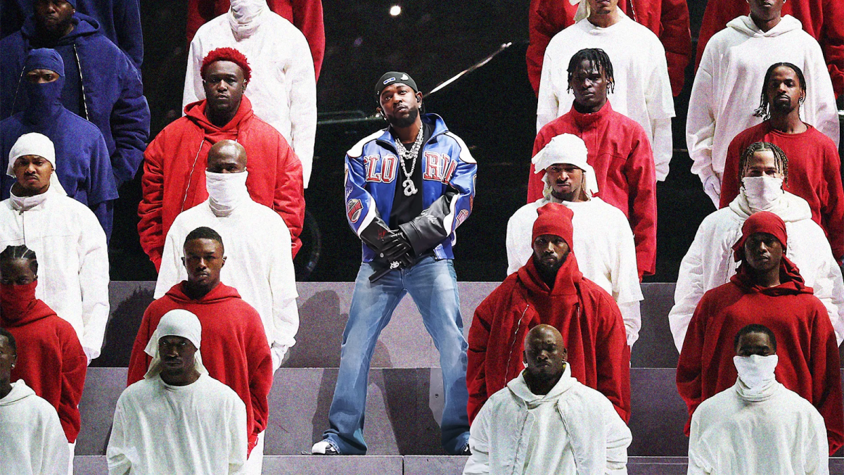 Kendrick Lamar standing onstage amid his Super Bowl LIX performance (GQ).