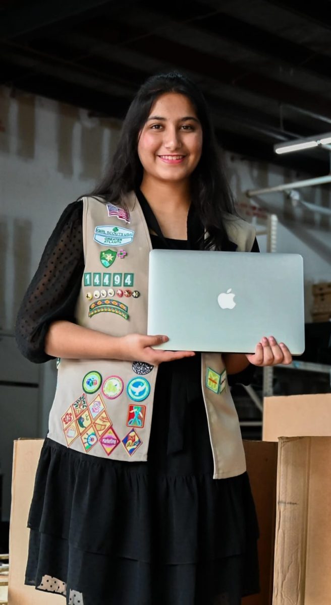 Loladia holding one of the donated electronics (Nazeefa Loladia).

